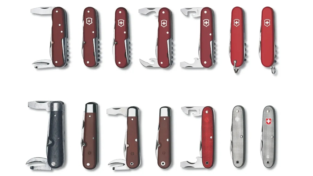 Series of pocket knives arranged in two rows, showing different shapes, colours and opened tools, illustrating various stages of their evolution.