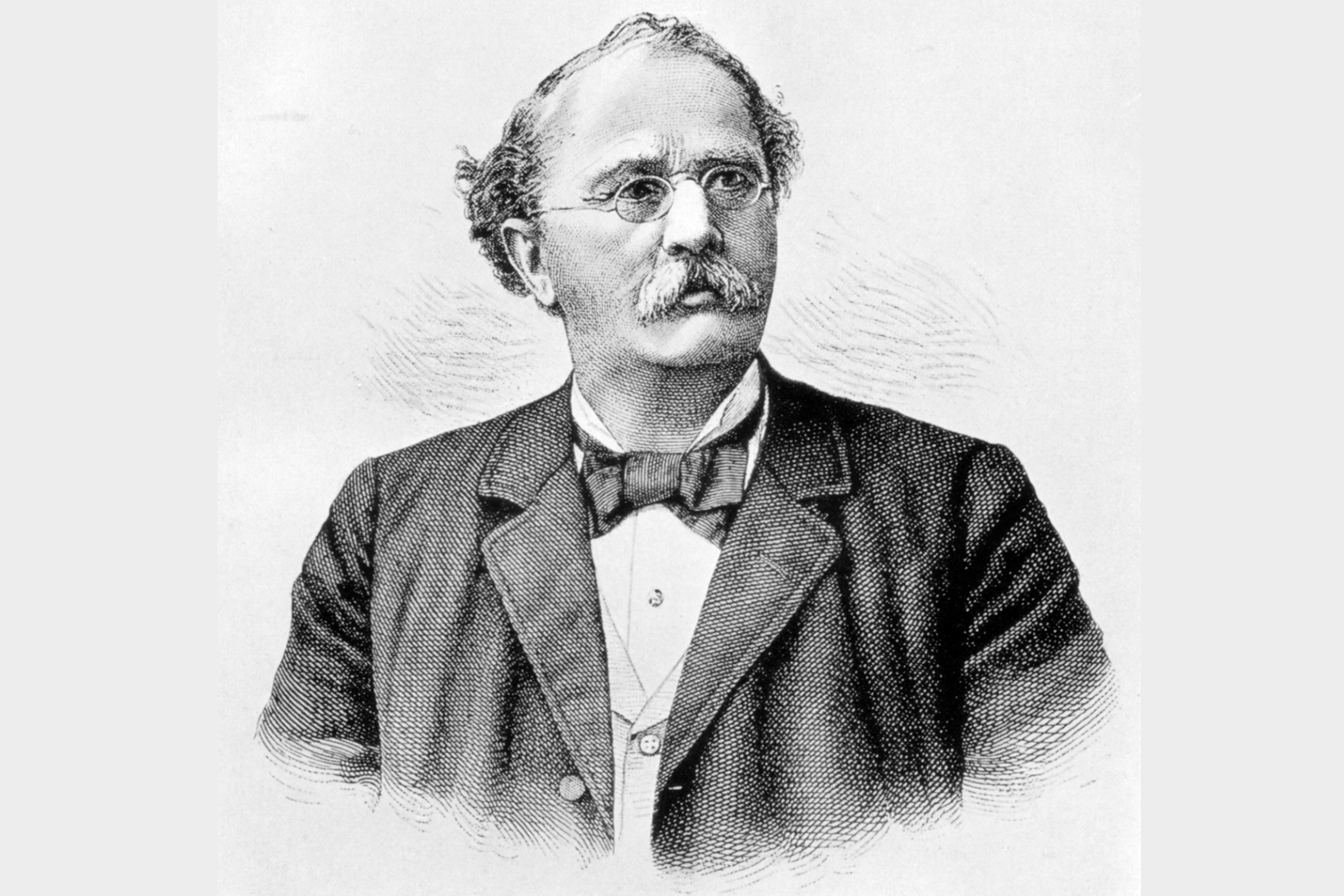 Black and white portrait of a man in a suit with a bow tie.