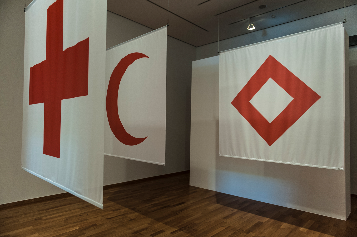Photo of the red cross, red crescent and red crystal emblems.