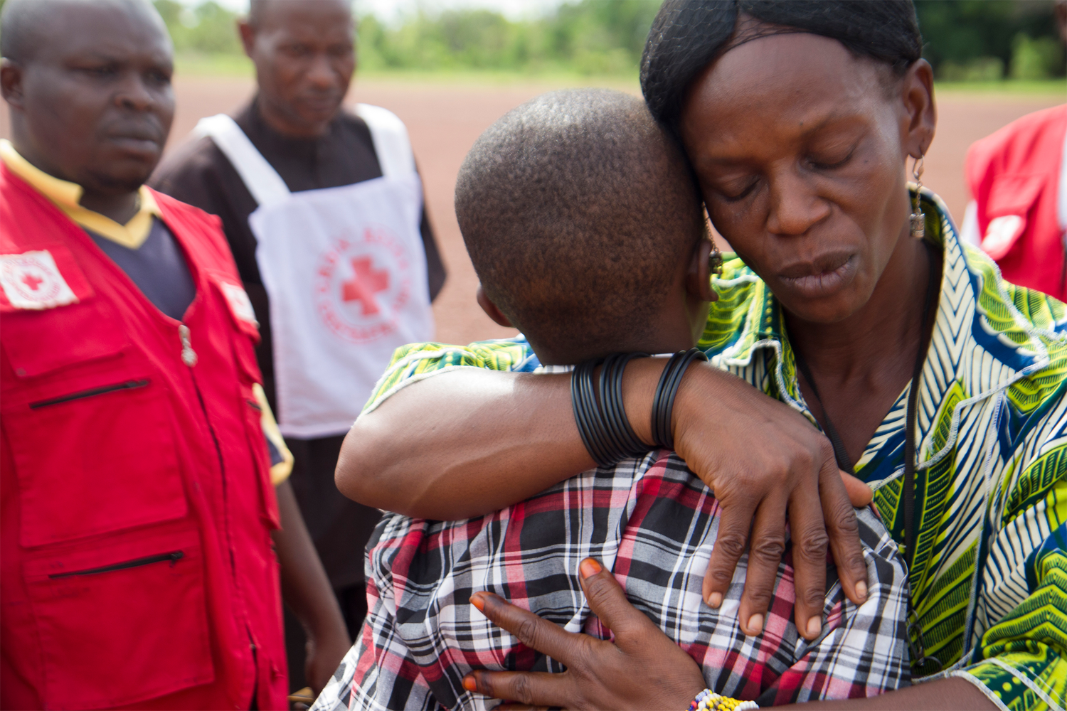 A mother holds her son after a year's separation in a war torn country.