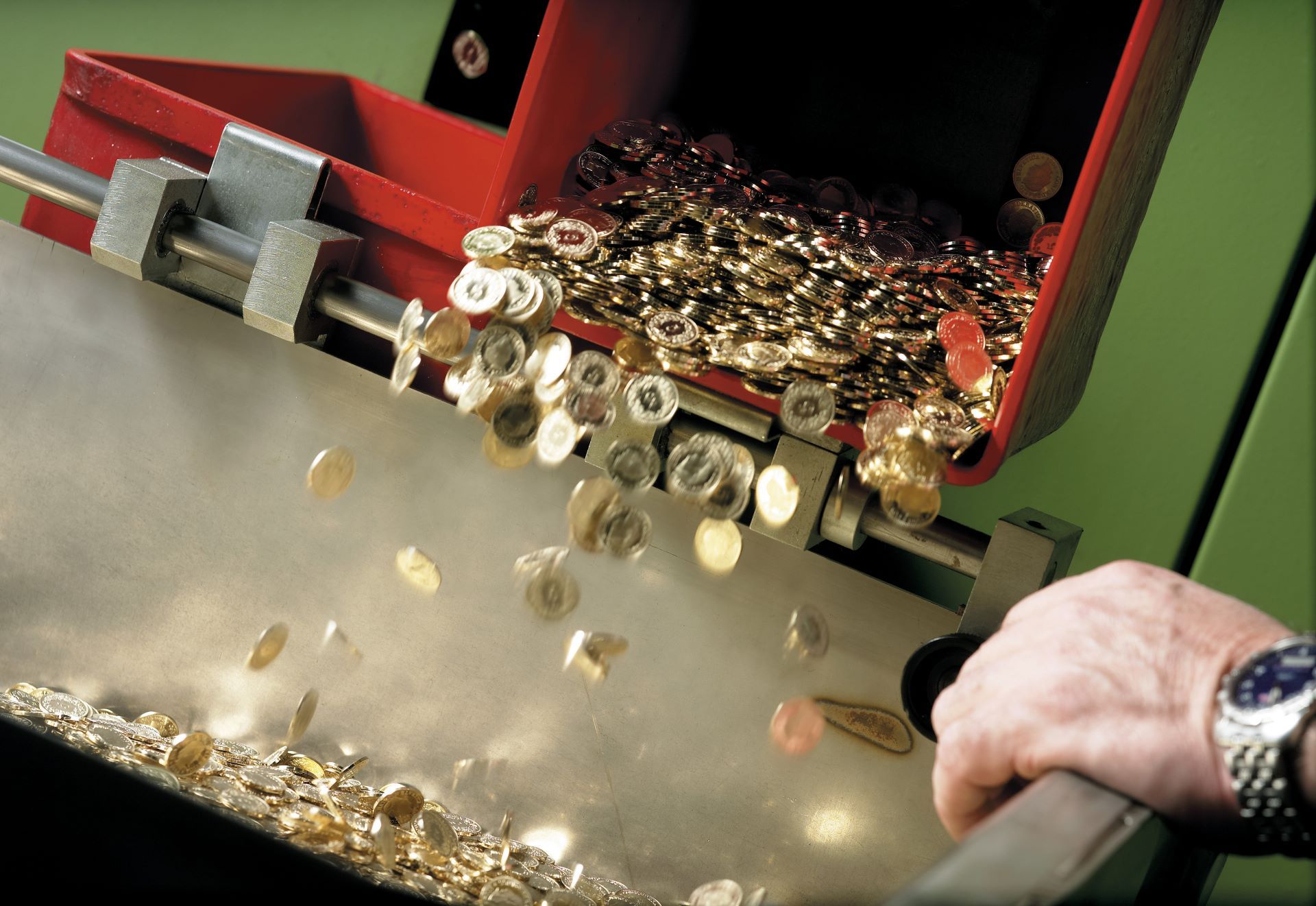 Swiss franc pieces falling out of a machine