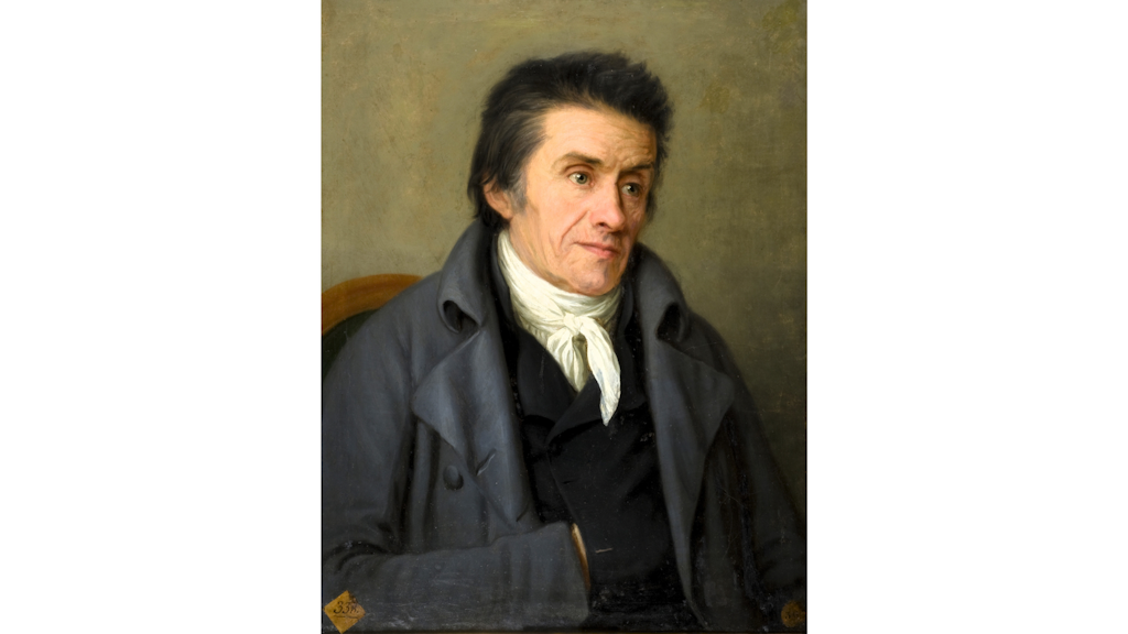 Portrait de Johann Heinrich Pestalozzi en buste trois quarts, vêtu d’un manteau gris et d’un foulard blanc, sur fond uni. 